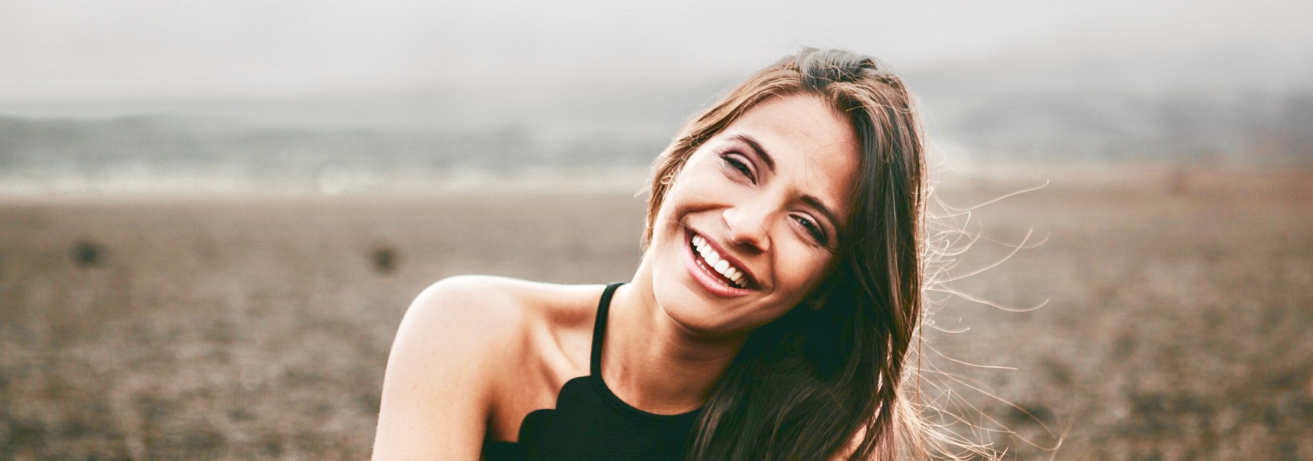 Smiling girl with mountain background.