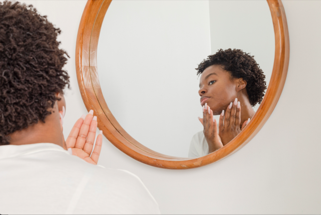 Woman examining her skin in the mirror