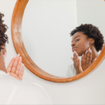 Woman examining her skin in the mirror