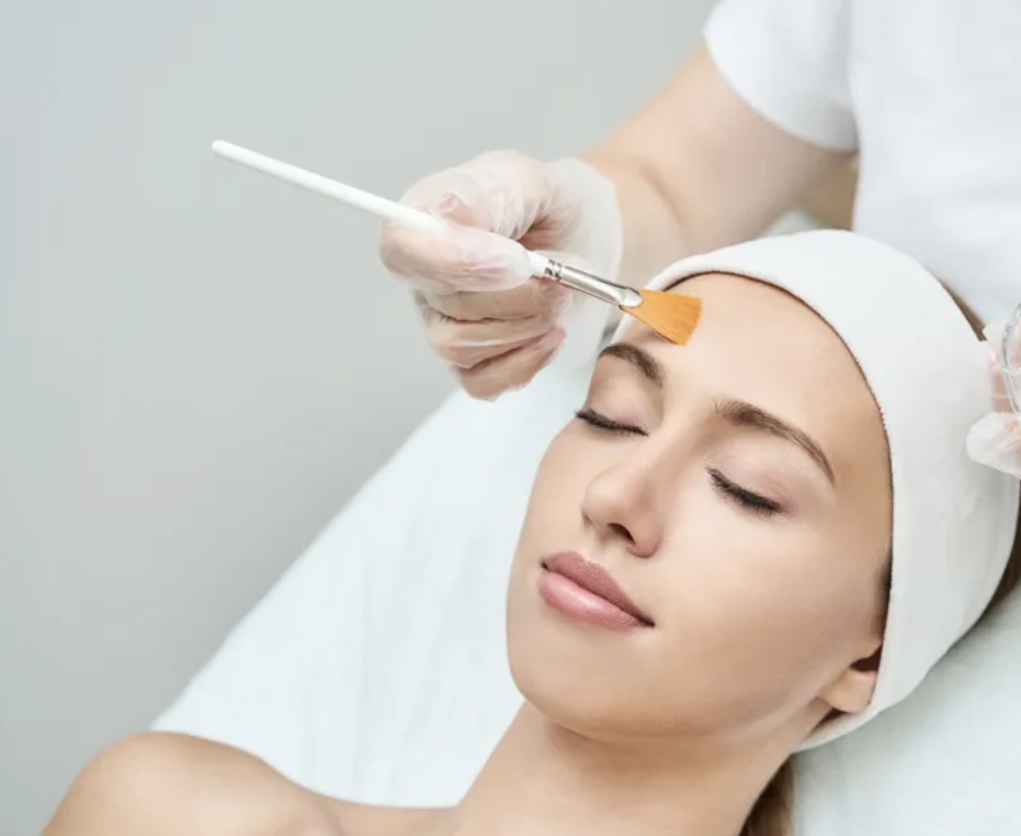 Women laying receiving a checmical peel treatment