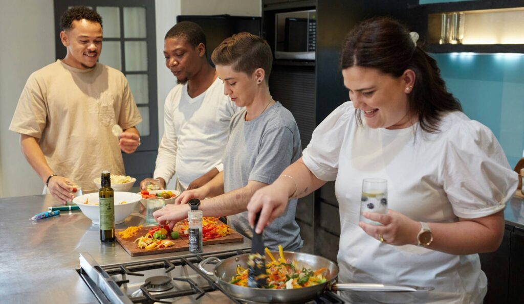 Group cooking healthy food in the kitchen