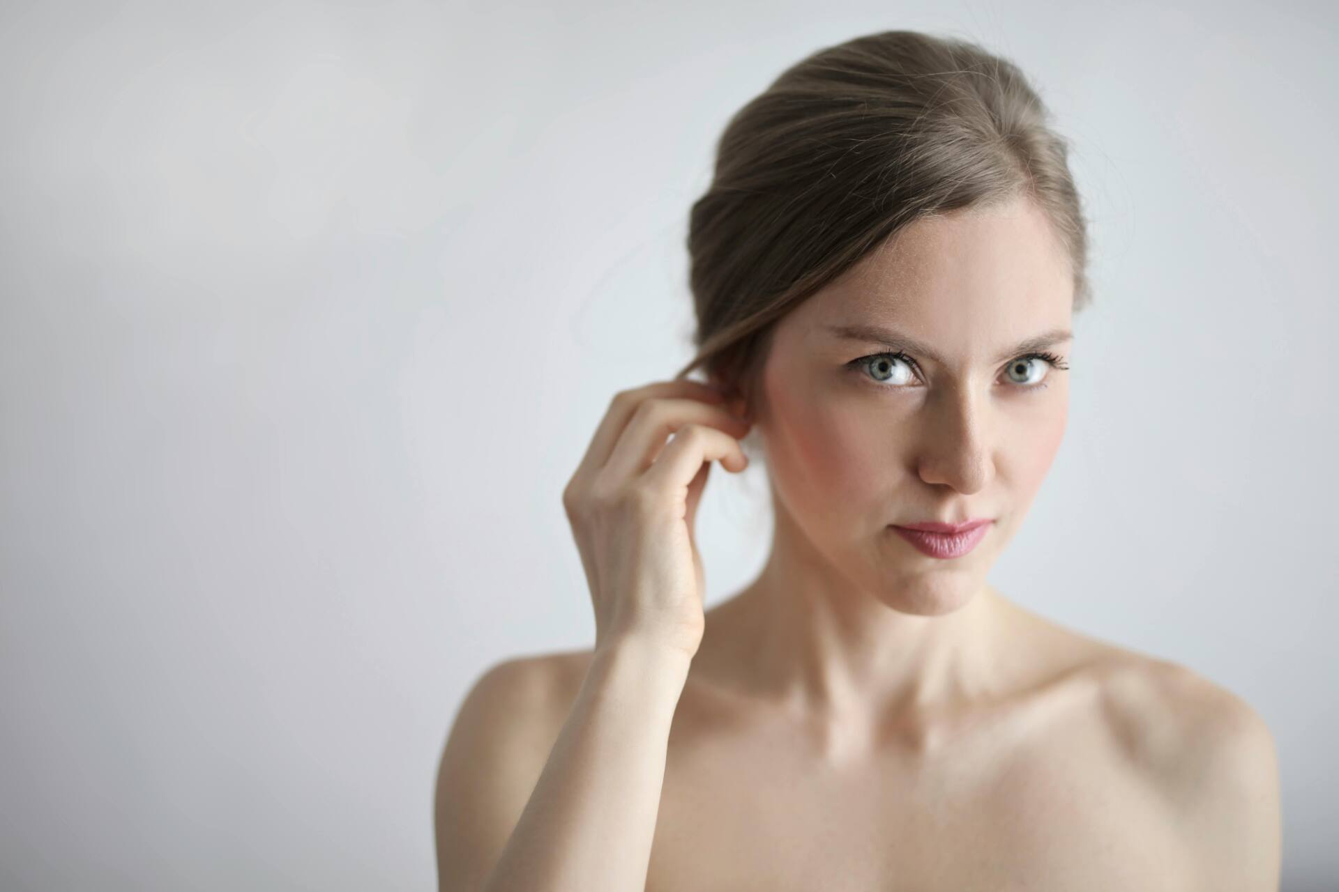 Woman brushing hair behind ear