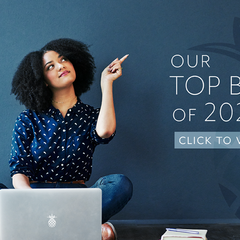 Our top blogs is 2022! A woman on a computer is pointing to the title