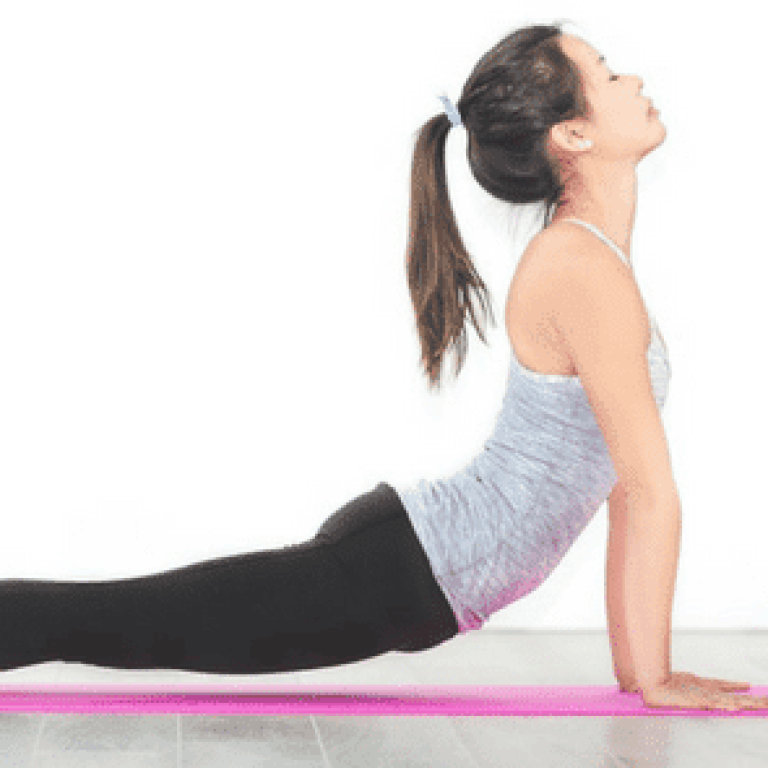 Woman doing yoga on pink yoga mat