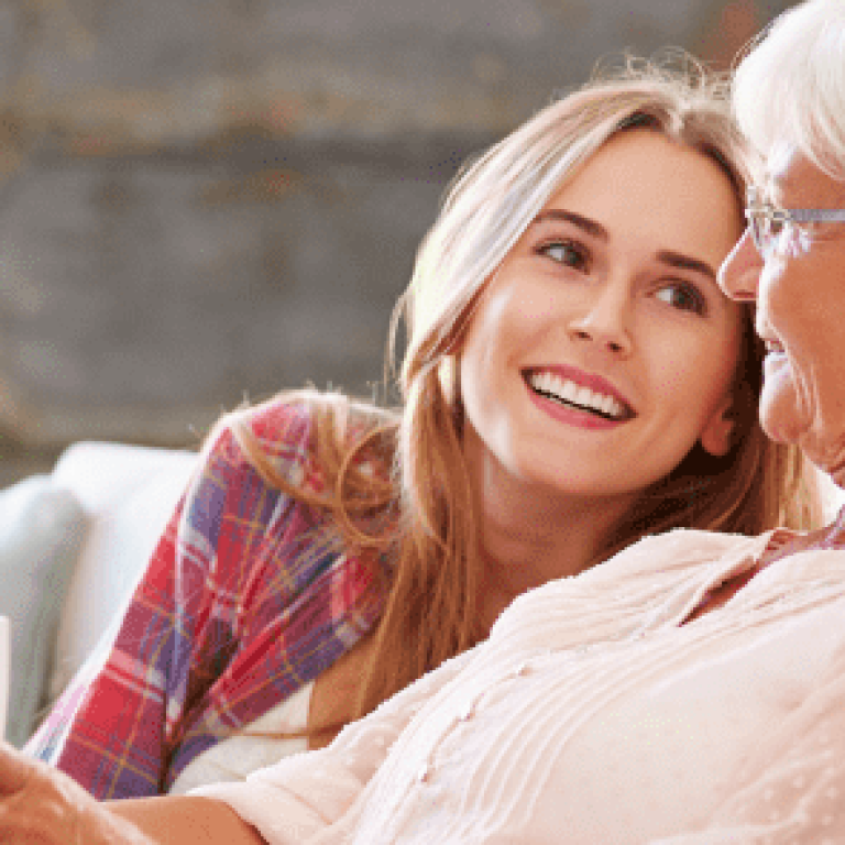 Daughter and grandmother talking on the couch