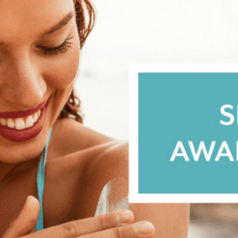 Skin Cancer Awareness Month with woman rubbing sunscreen on her arm