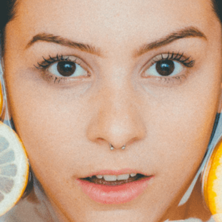 Woman's head in water surrounded by orange slices