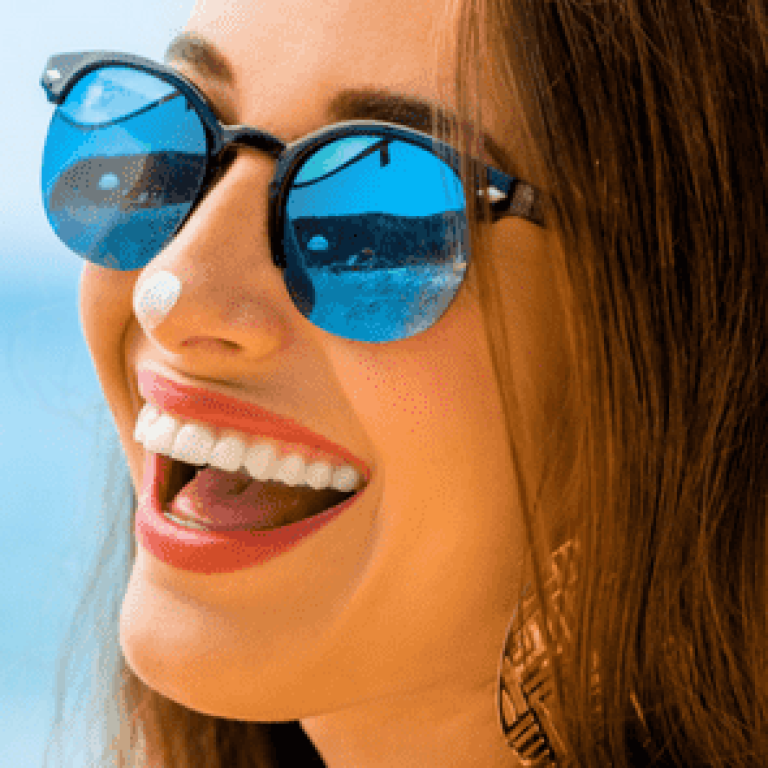 woman at the beach laughing