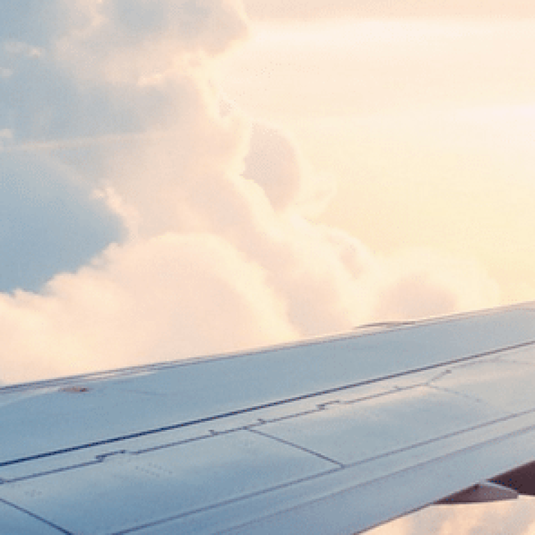 Airplane wing over the clouds