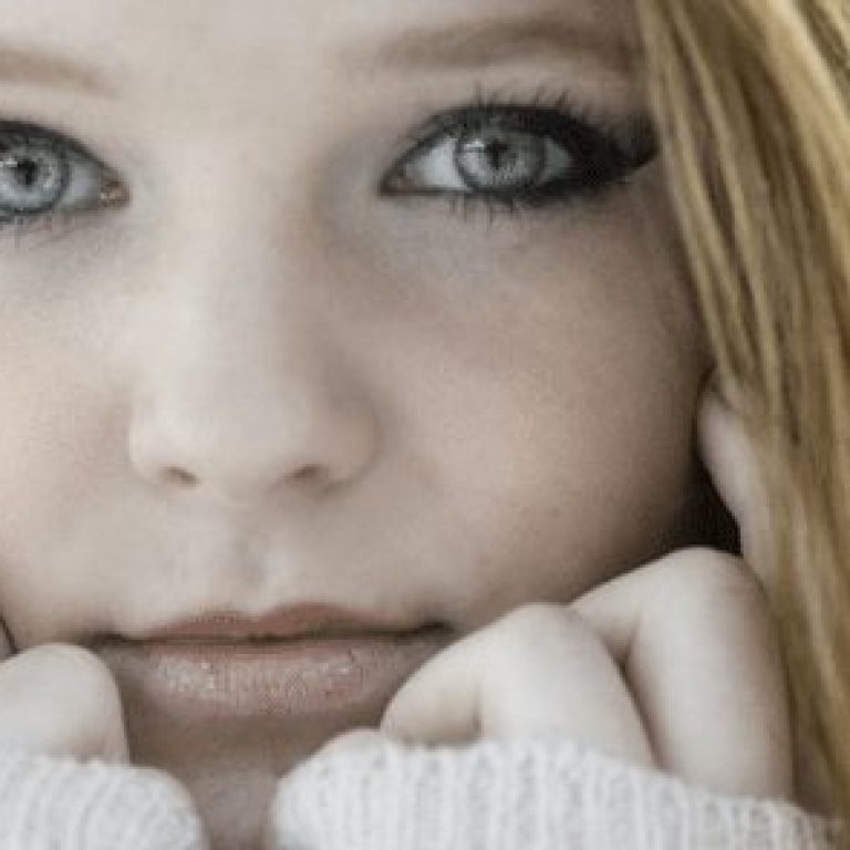 pale woman wearing a white sweater