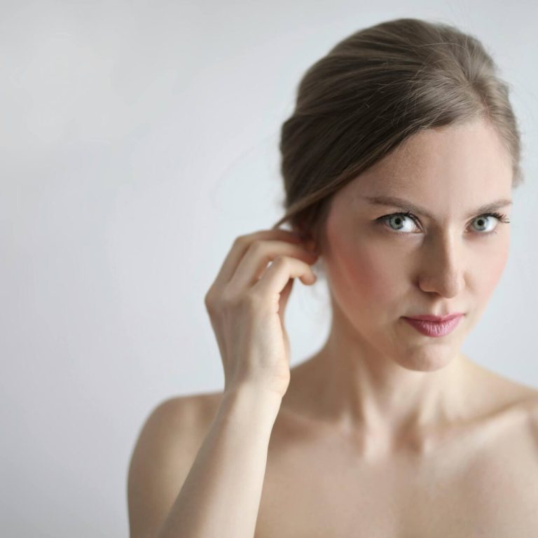 Woman brushing hair behind ear