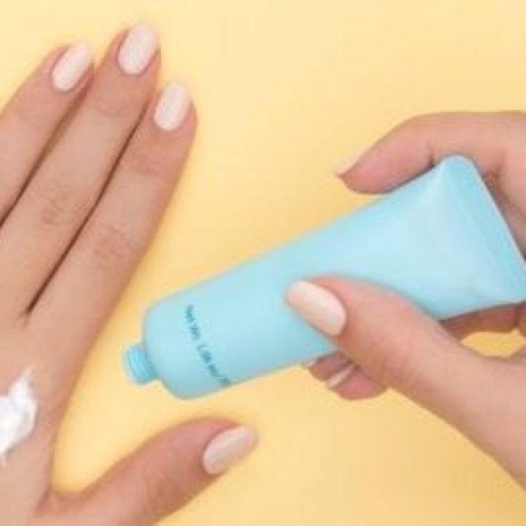 Person putting sunscreen on hand