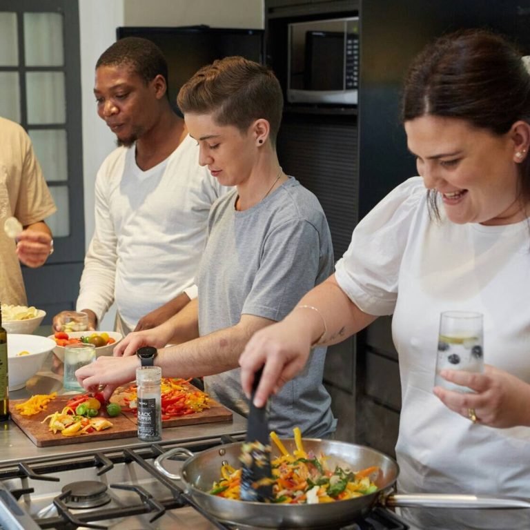 Group cooking healthy food in the kitchen