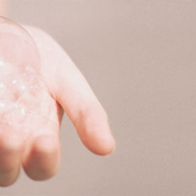 Hand holding soapy bubbles