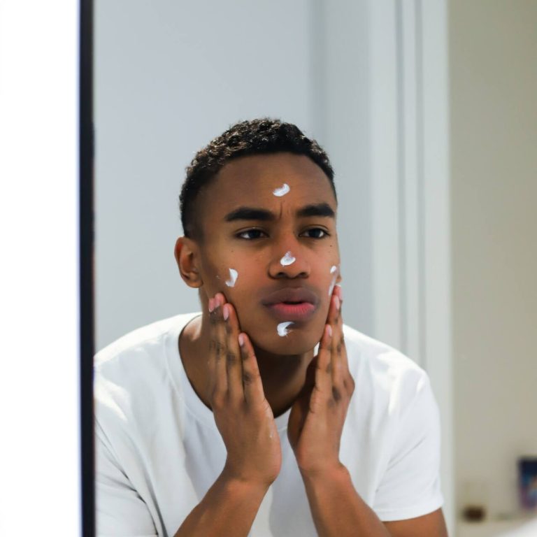 Man putting medicine on his face to help with blemishes