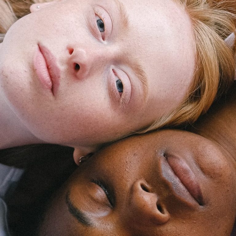Two women laying next to each other