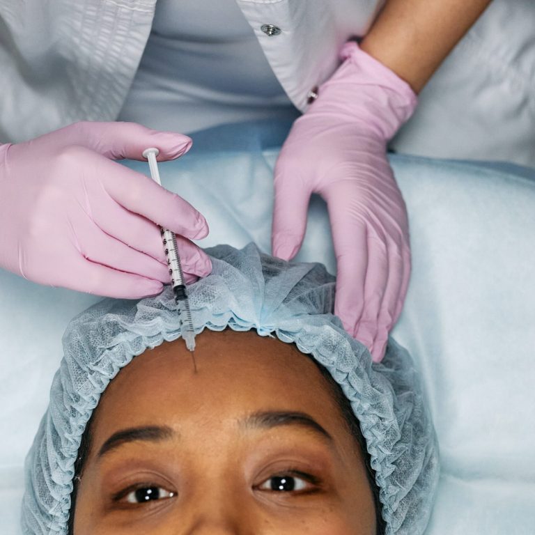 doctor injecting patient's forehead with a needle