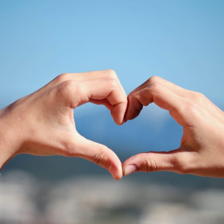 Person's hands making a heart