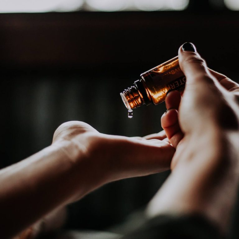 Pouring skincare seru onto hand