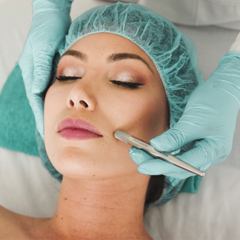 Doctor using a dermatologist tool on a patients face
