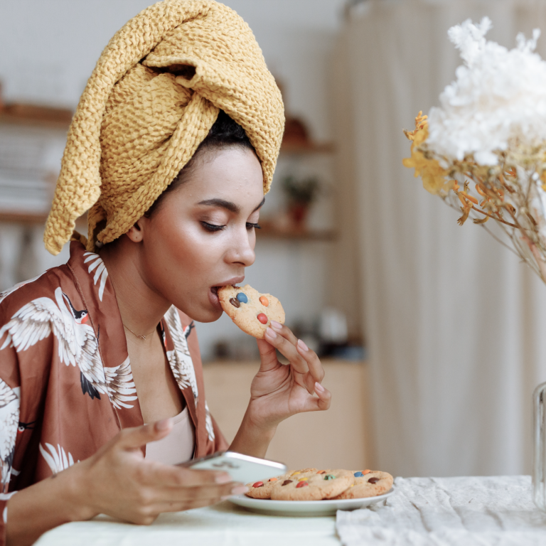Women with yellow towel on her head eating a cookie